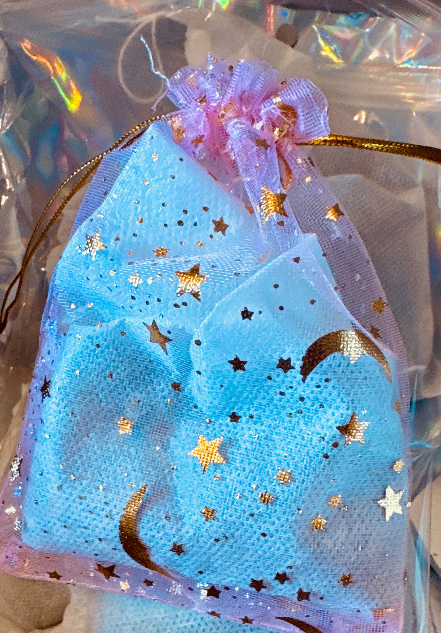 Goddess Aureline™ Bath Tea Bag with a rose quartz, strawberry quartz, and amethyst crystal nestled inside.